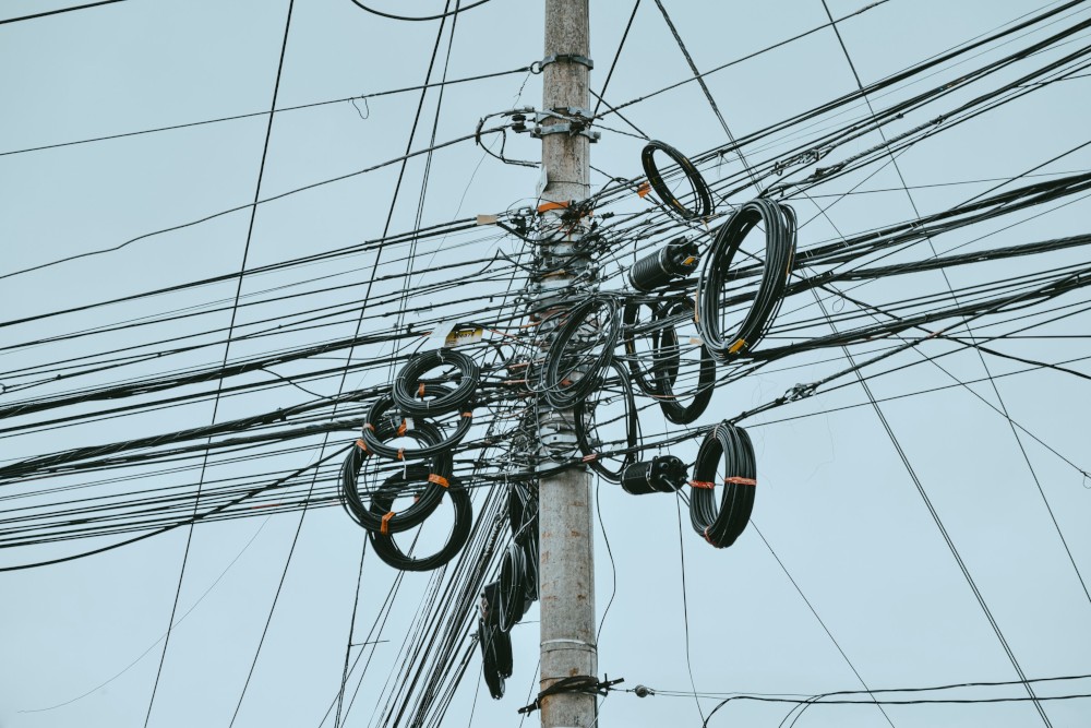 Telephone pole with many cables symbolising the complexity of build dependencies and toolchains
